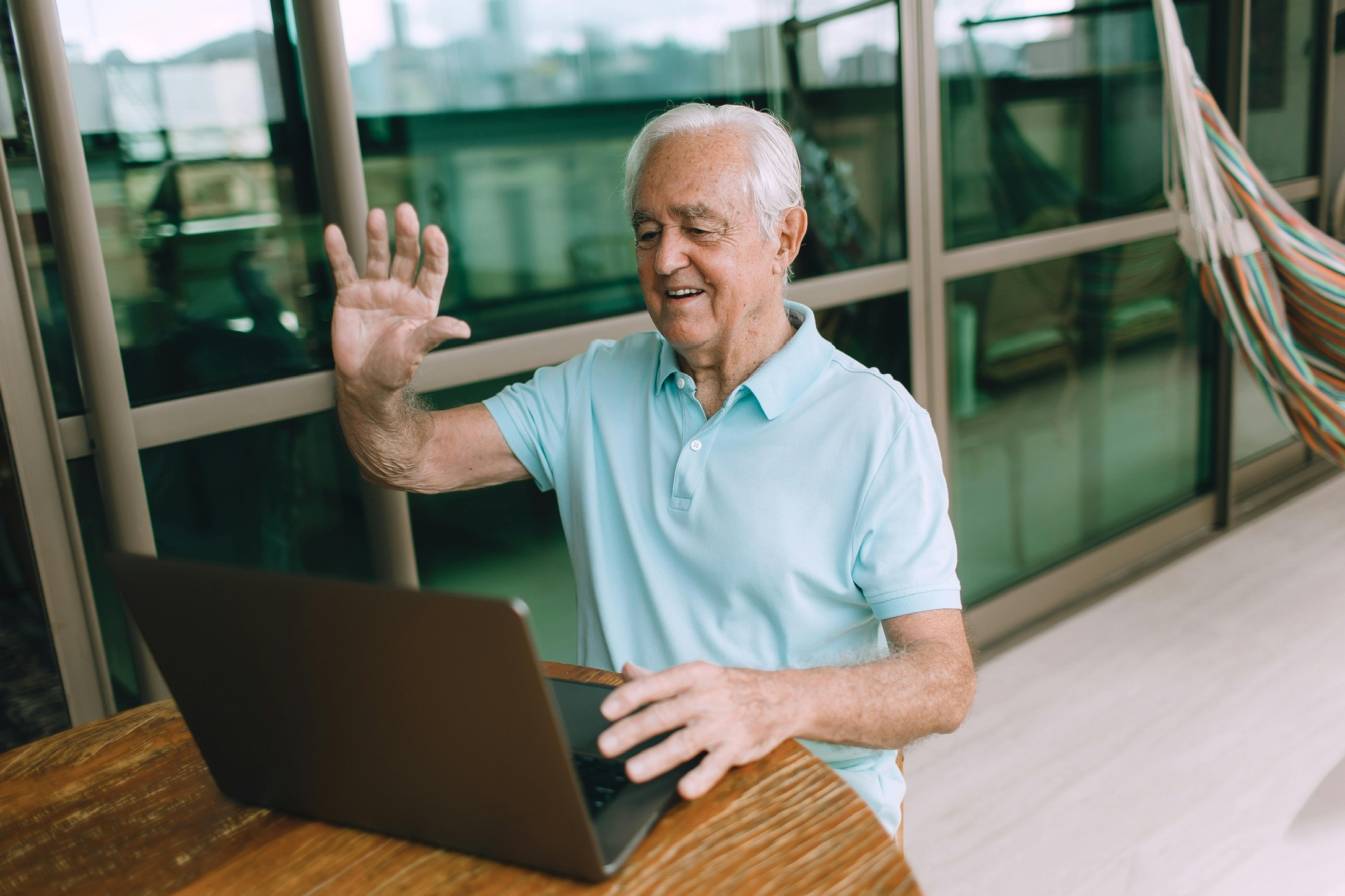 Senior man smiling on a phone call at home